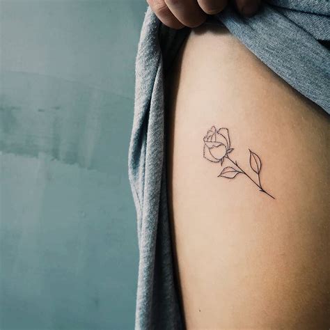 rose tattoo on thigh|small fine line rose tattoo.